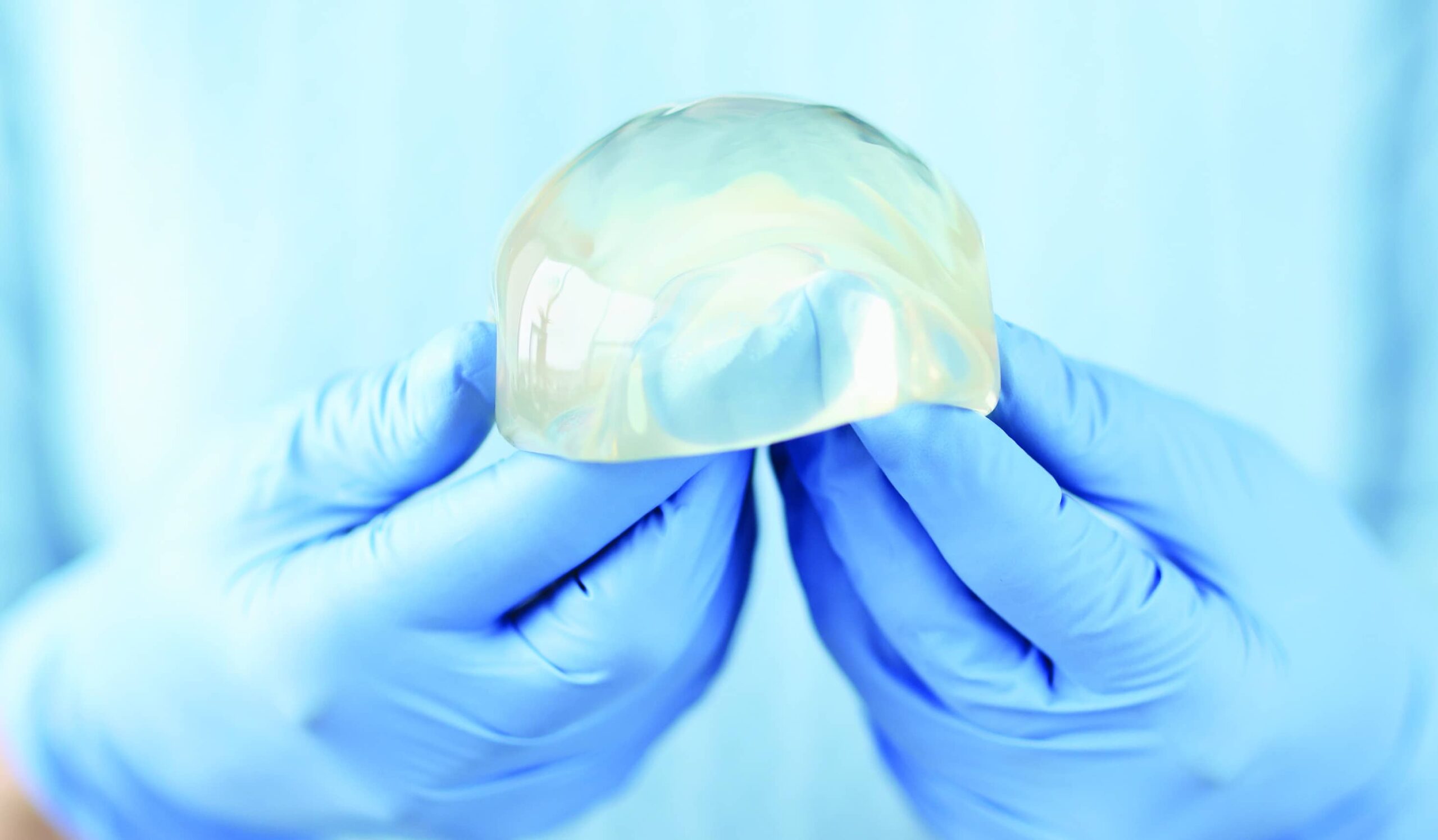 surgeon holding gummy bear implant