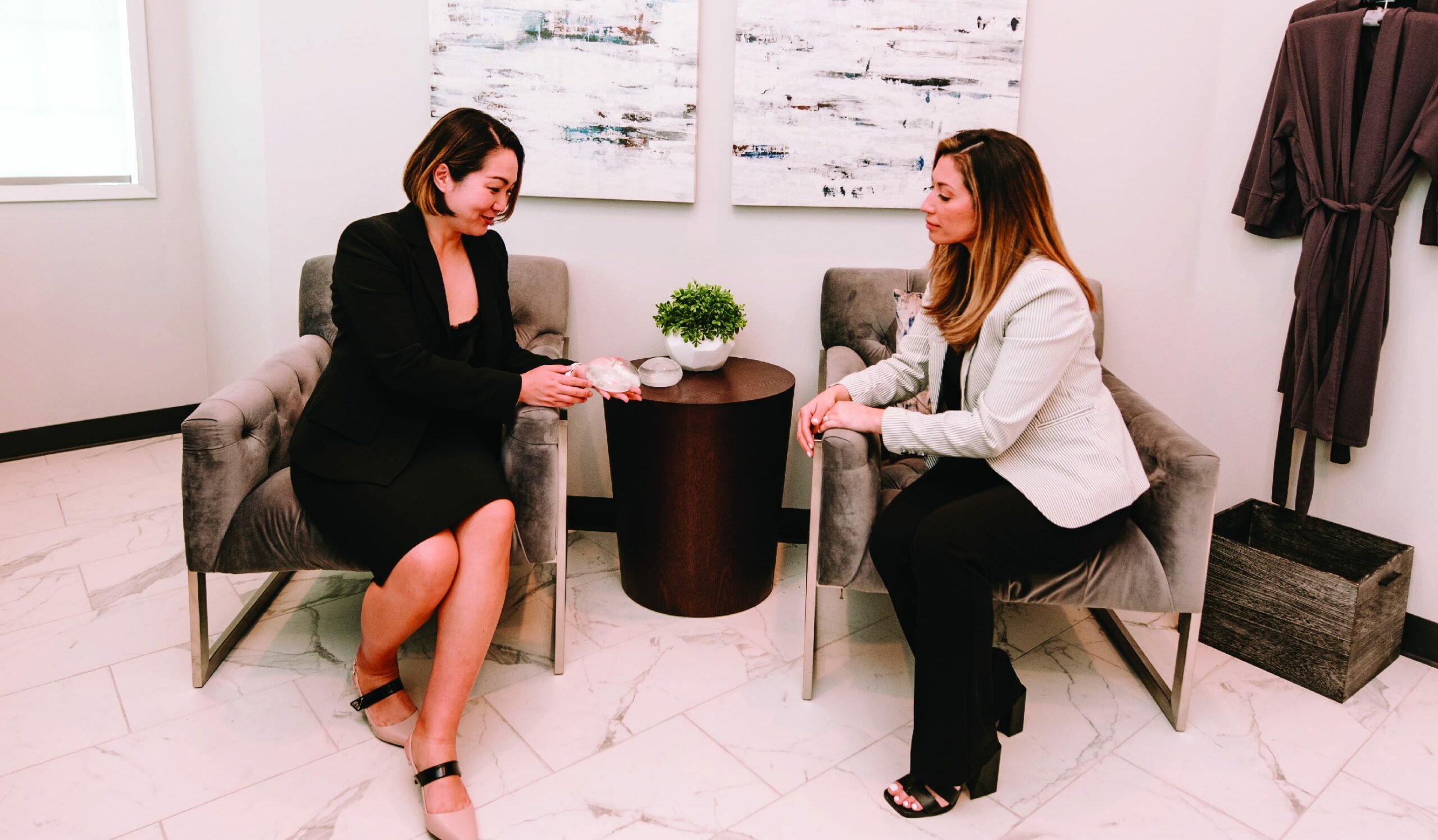 Plastic surgeon discussing procedure options with a patient during a consultation.