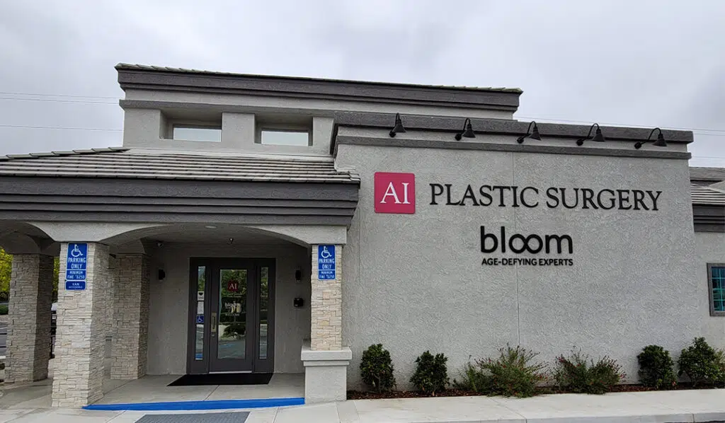 Front of the building in Temecula showcasing the Bloom and Advanced Institute for Plastic Surgery logos with beautiful landscaping surrounding the entrance.